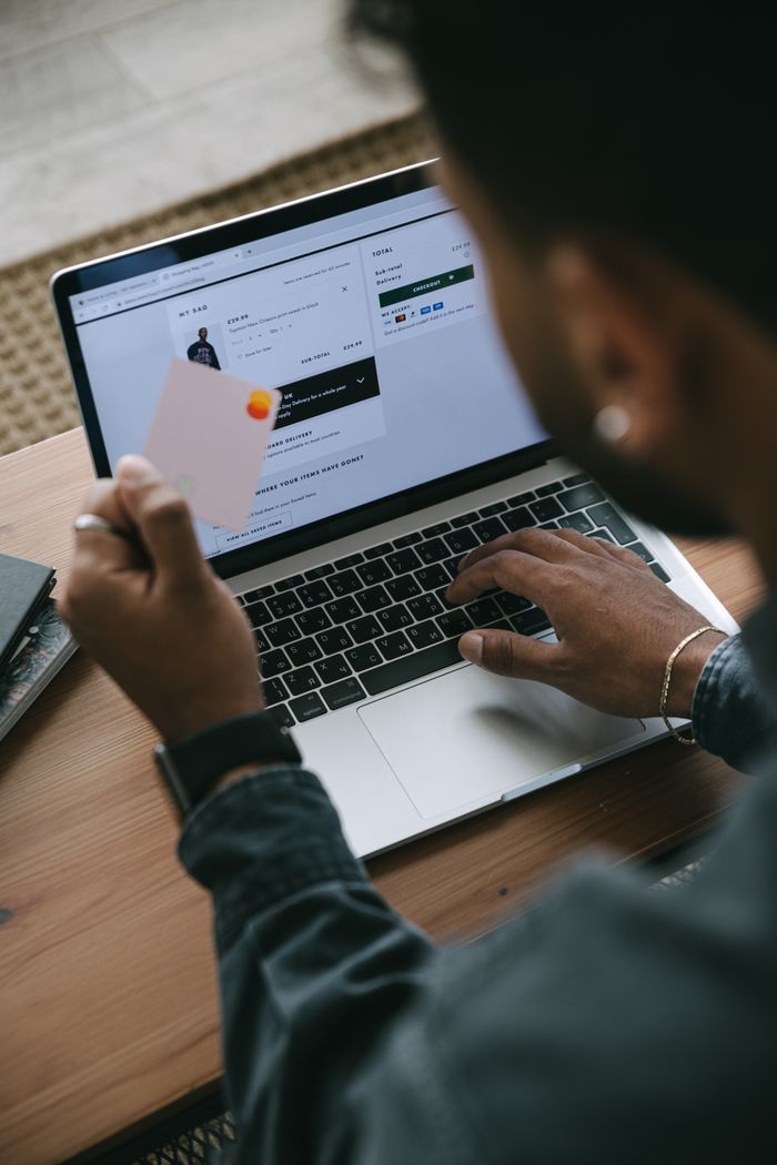 Services Person shopping online using a laptop and credit card.